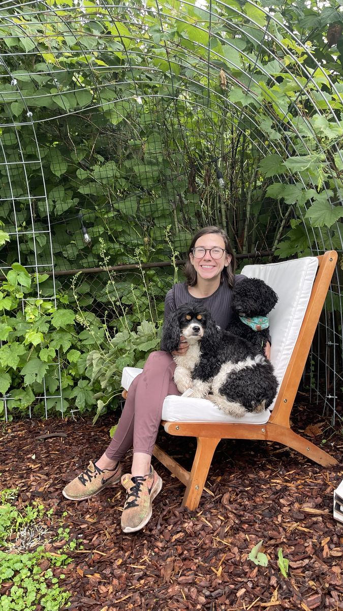 Haley in a garden chair under a leafy arch, with Colt and Wes on her lap