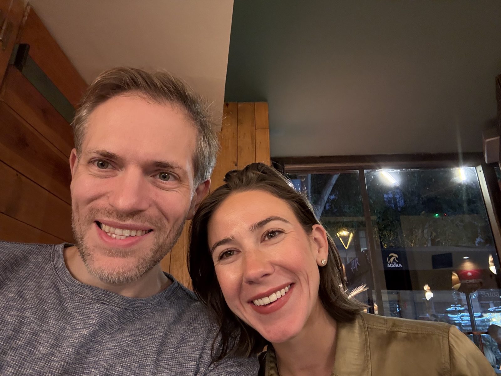 Haley and Michael in a selfie at a restaurant with wood walls