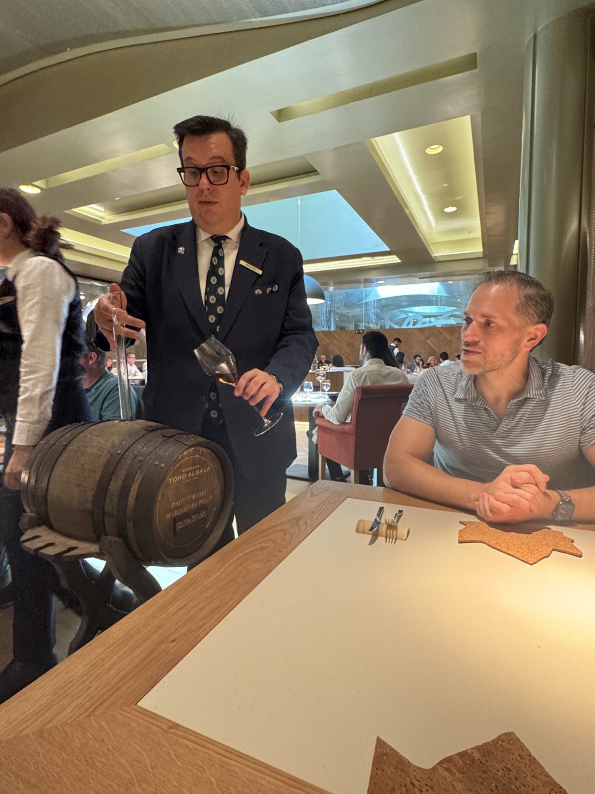 A sommelier pouring palo cortado sherry from a small Toro Albalá barrel at Michael's table